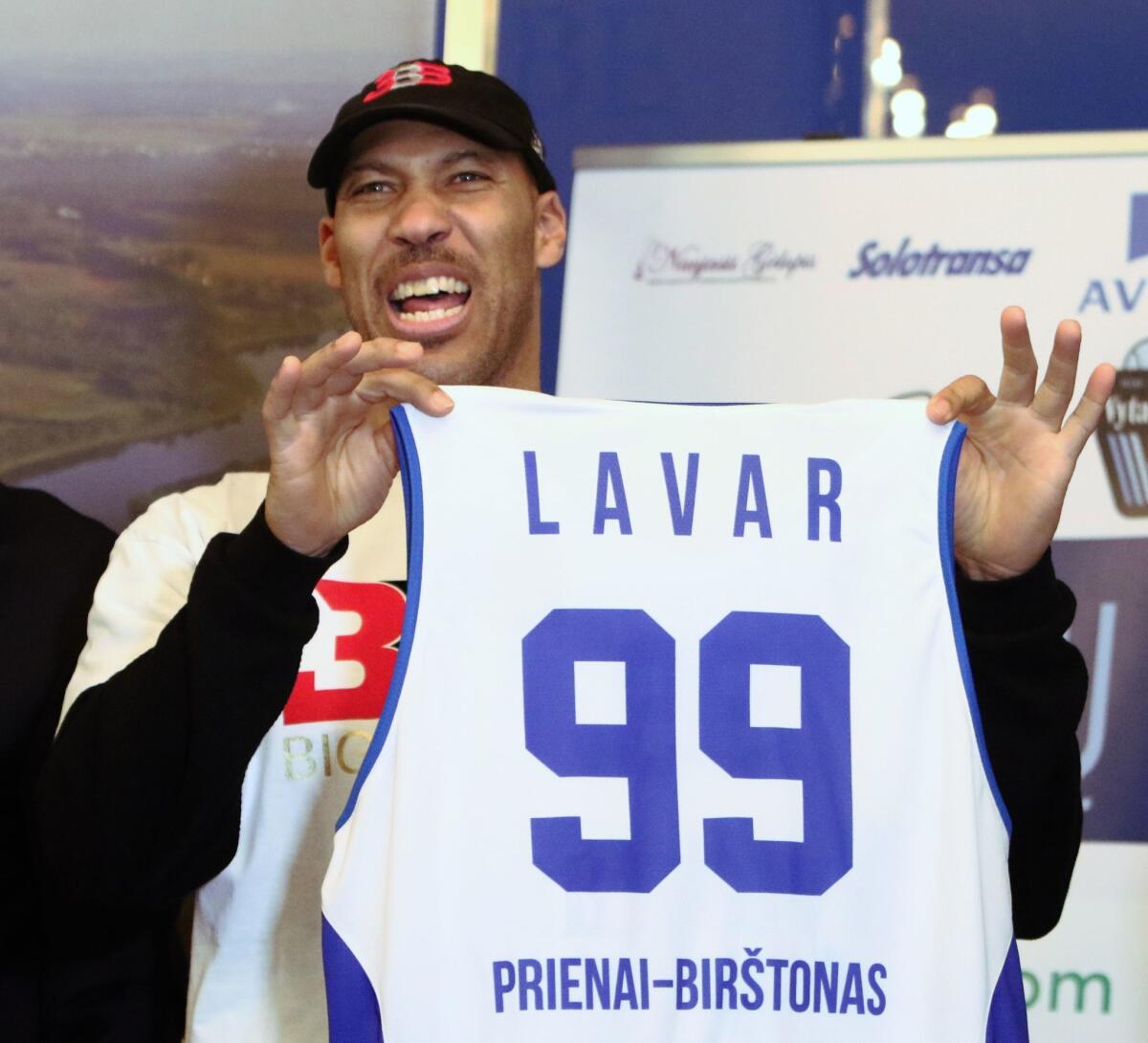 LaVar Ball holds up a team jersey during a news conference in Prienai, Lithuania, on Jan. 5.