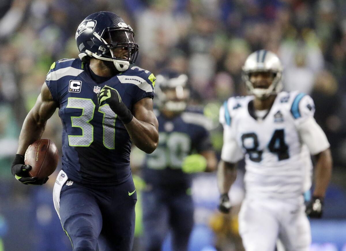 Seattle safety Kam Chancellor runs for a touchdown after an interception against Carolina in January.