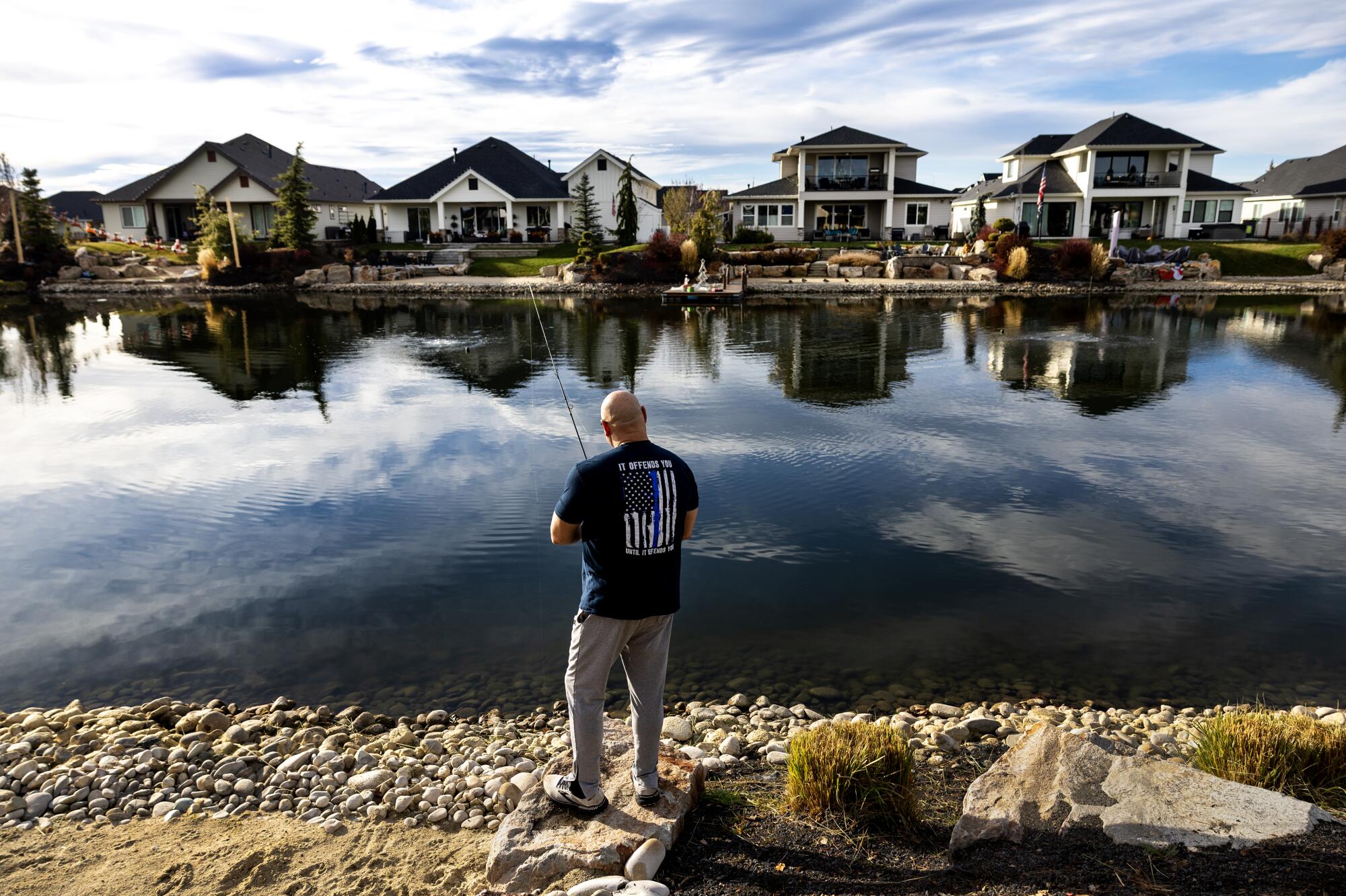 A man fishes on a man-made pond in Eagle, Idaho. 