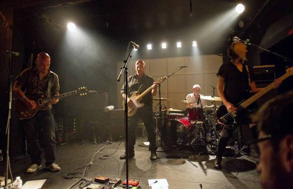 The Pixies lead guitarist Joey Santiago, from left, singer Black Francis, drummer David Lovering and bassist Kim Shattuc perform at the Echo in Los Angeles on Sept. 6, 2013.