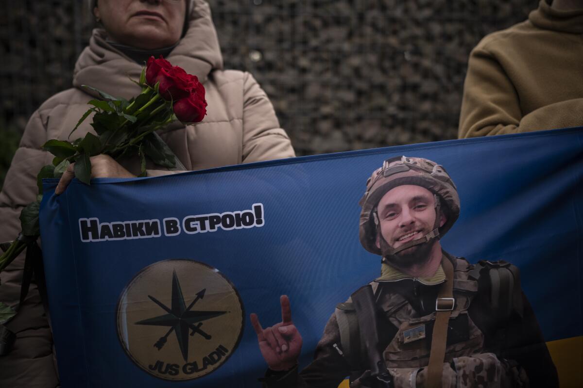 Banner with a picture of Ukrainian soldier, at his funeral in Kyiv, Ukraine