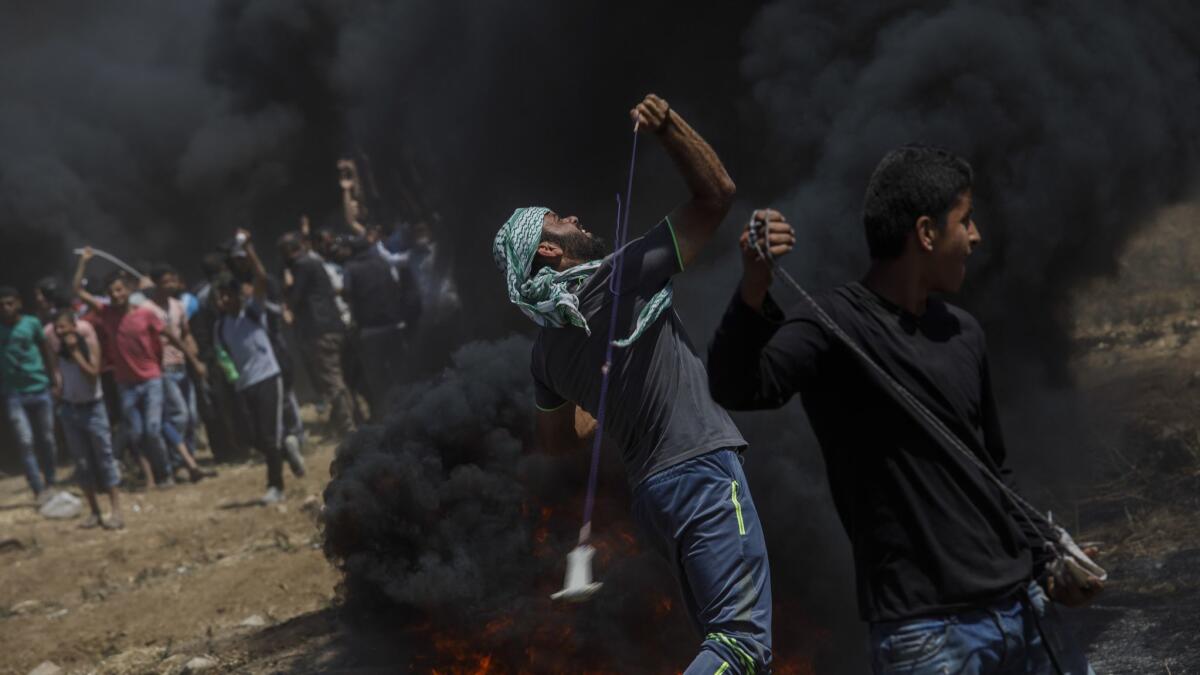Protesters deploy projectiles toward the border fence separating Israel and the Gaza Strip.
