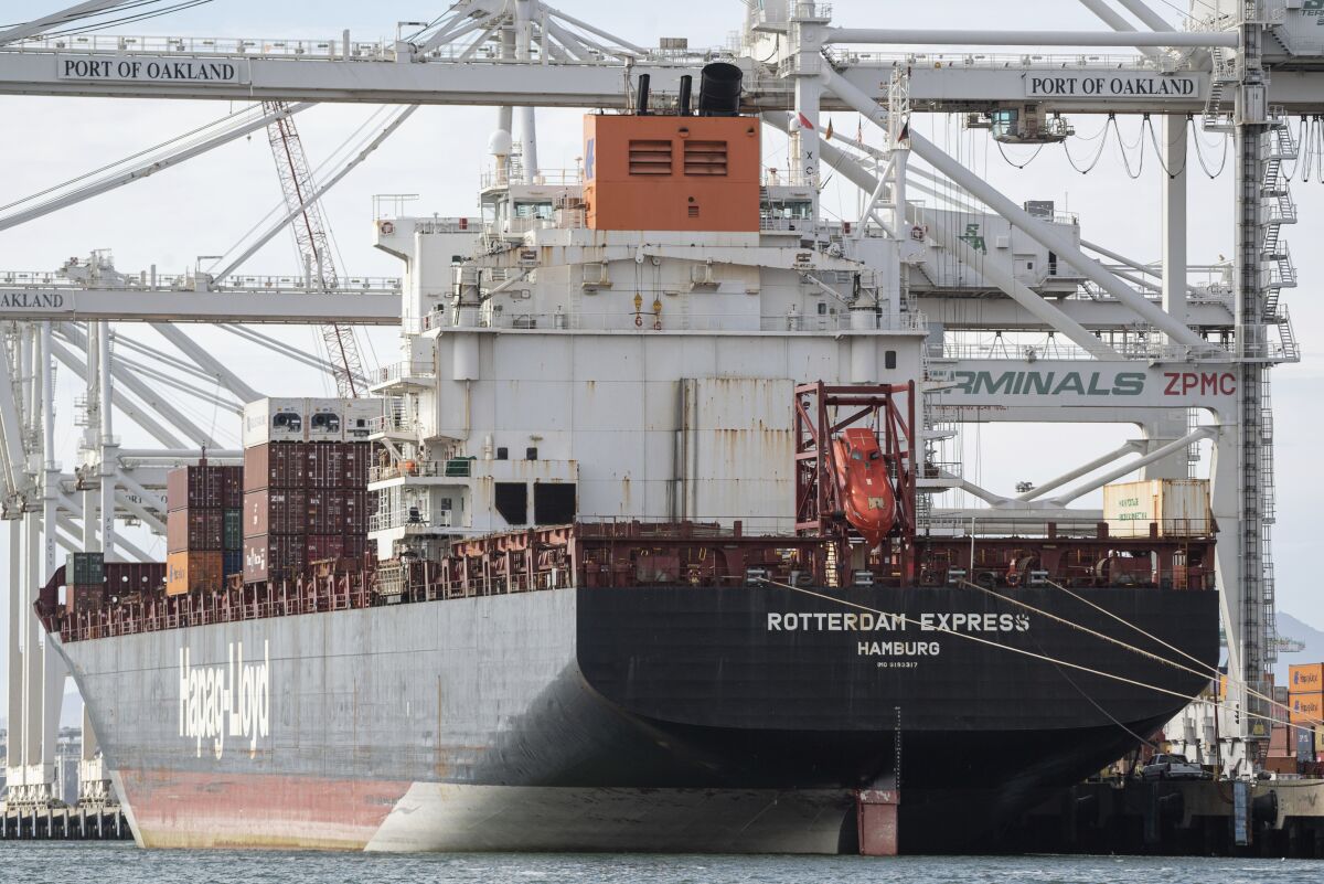 A cargo ship sits at port in Oakland.