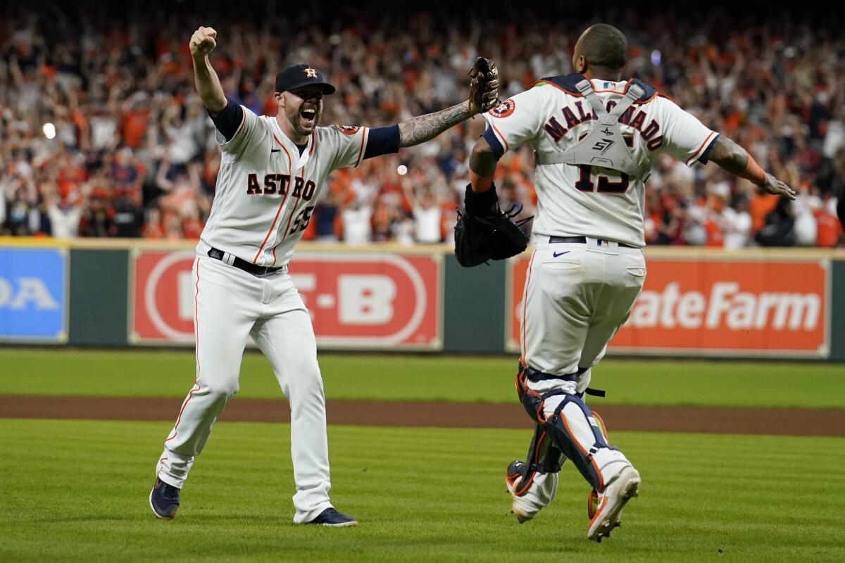 Astros reliever Ryan Pressly and catcher Martin Maldonado celebrate their win in Game 6 of ALCS on Friday.