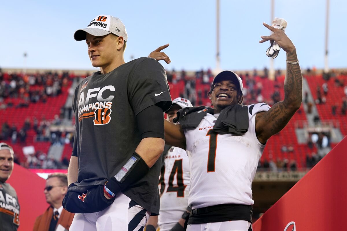 Cincinnati Bengals quarterback Joe Burrow, left, and wide receiver Ja'Marr Chase (1) celebrate after the AFC championship NFL football game against the Kansas City Chiefs, Sunday, Jan. 30, 2022, in Kansas City, Mo. The Bengals won 27-24 in overtime. (AP Photo/Eric Gay)