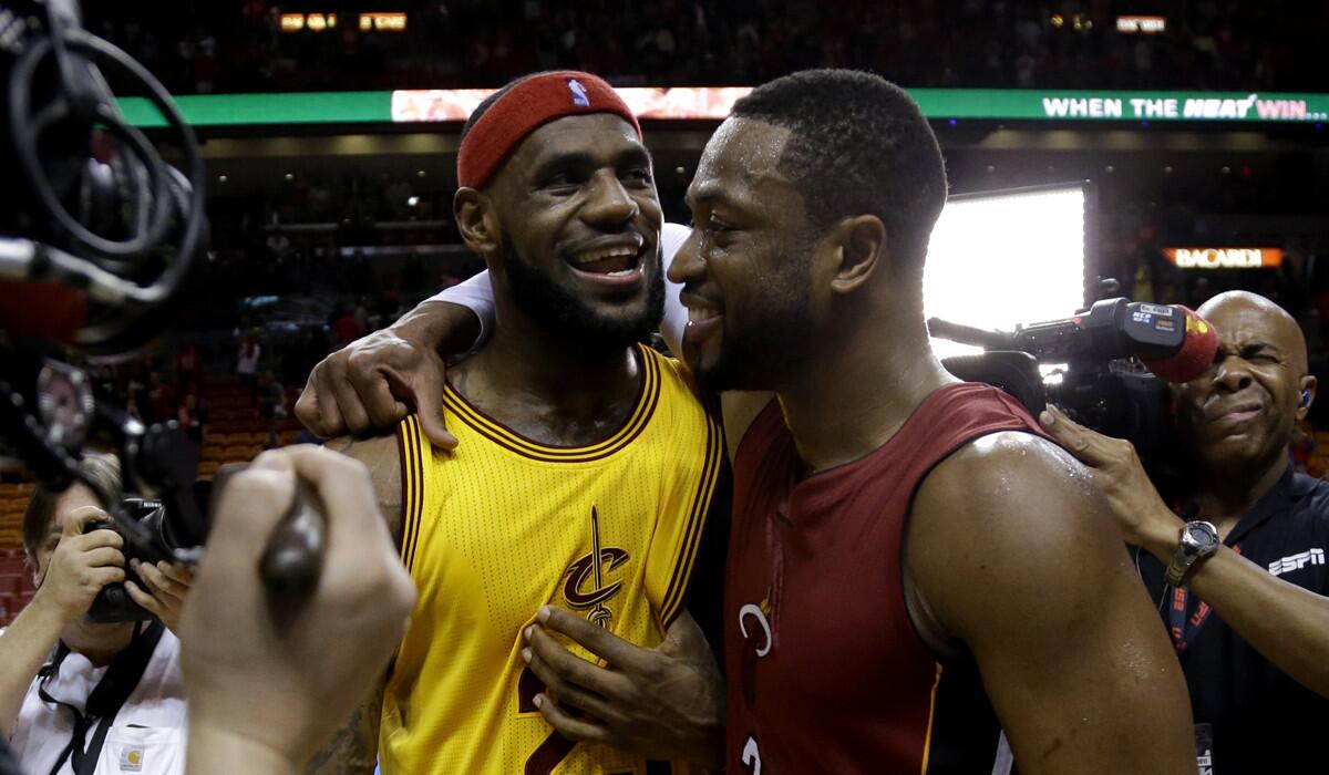 LeBron James, left, and Dwyane Wade embrace after their Christmas Day game.