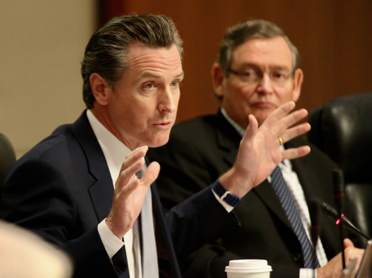 Lt. Gov. Newsom, left, asks the CSU Board of Trustees to reject the proposed tuition hike Wednesday morning in Long Beach.