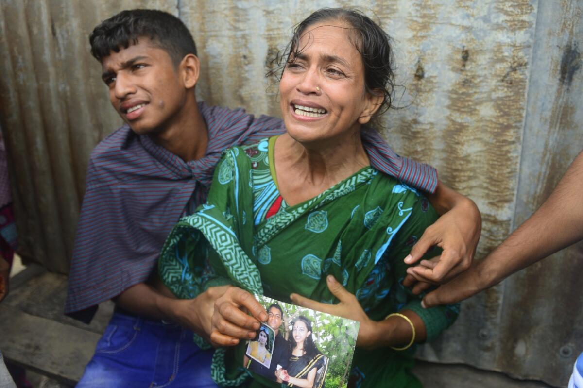 Bangladeshis mourn for missing relatives after an overloaded ferry capsized in the Padma river in Munshiganj, about 20 miles south of the capital, Dhaka.