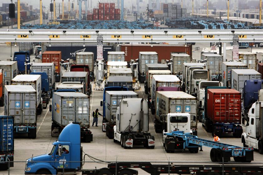 LOS ANGELES, CA - DECEMBER 05, 2012: Trucks line up as work resumes at the APM Terminals and California United Terminals located at 2500 Navy Way on Terminal Island in the Port of Los Angeles as clerical workers at the ports of Los Angeles and Long Beach returned to work Wednesday morning December 05, 2012, ending a strike that crippled America's busiest shipping hub for more than a week. Leaders of the 800-member International Longshore and Warehouse Union Local 63 Office Clerical Unit agreed to a tentative deal after marathon negotiations that ended late Tuesday. The deal will not bec ome final until it is retified by the full union membership. (Al Seib / Los Angeles Times)