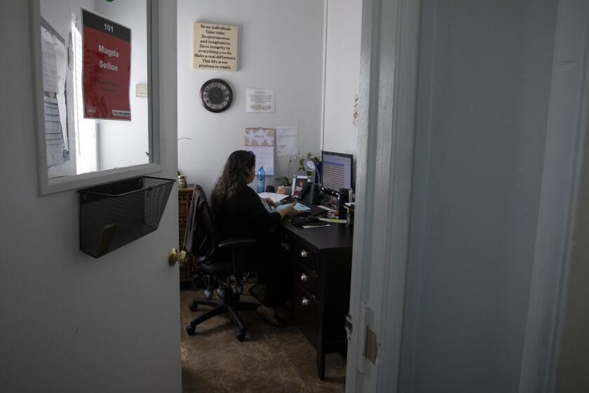 GLENDALE, CALIF. - MARCH 17: Housing Program Supervisor Magda Sellon is in her office at the YWCA in Glendale, Calif. on Tuesday, March 17, 2020. With the threat of COVID-19 the YWCA is being closed to the public. Most of the workers will provide services to victims of domestic violence through video conferencing or over the phone. (Francine Orr / Los Angeles Times)