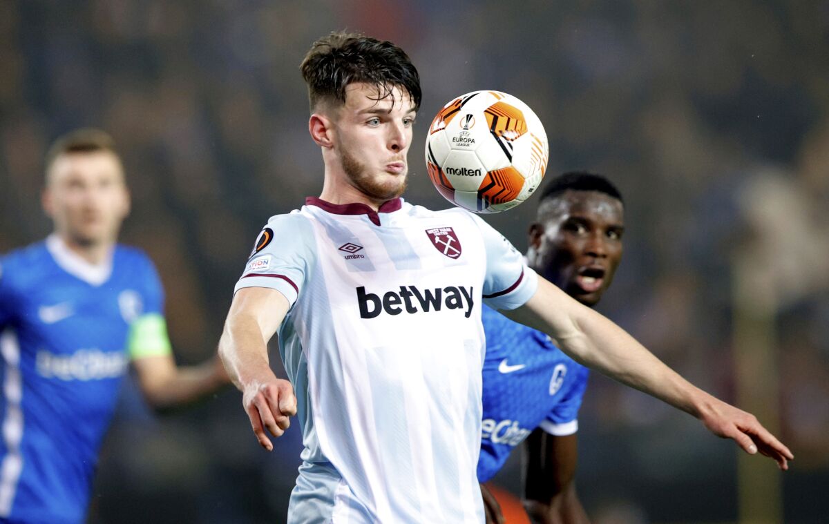 West Ham's Declan Rice, center, eyes the ball during a group H Europa League soccer match between Genk and West Ham at the KRC Genk Arena in Genk, Belgium, Thursday, Nov. 4, 2021. (AP Photo/Olivier Matthys)