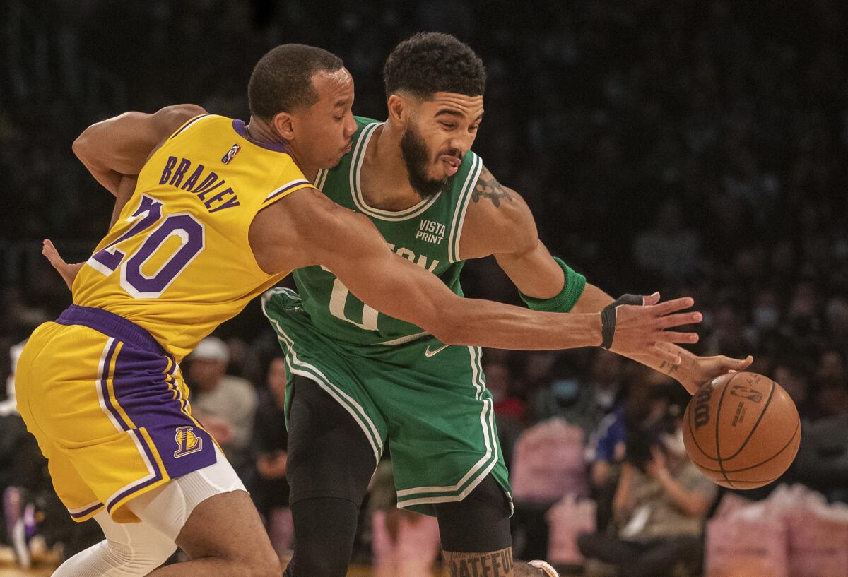 Lakers guard Avery Bradley reaches for the steal against Celtics forward Jayson Tatum.