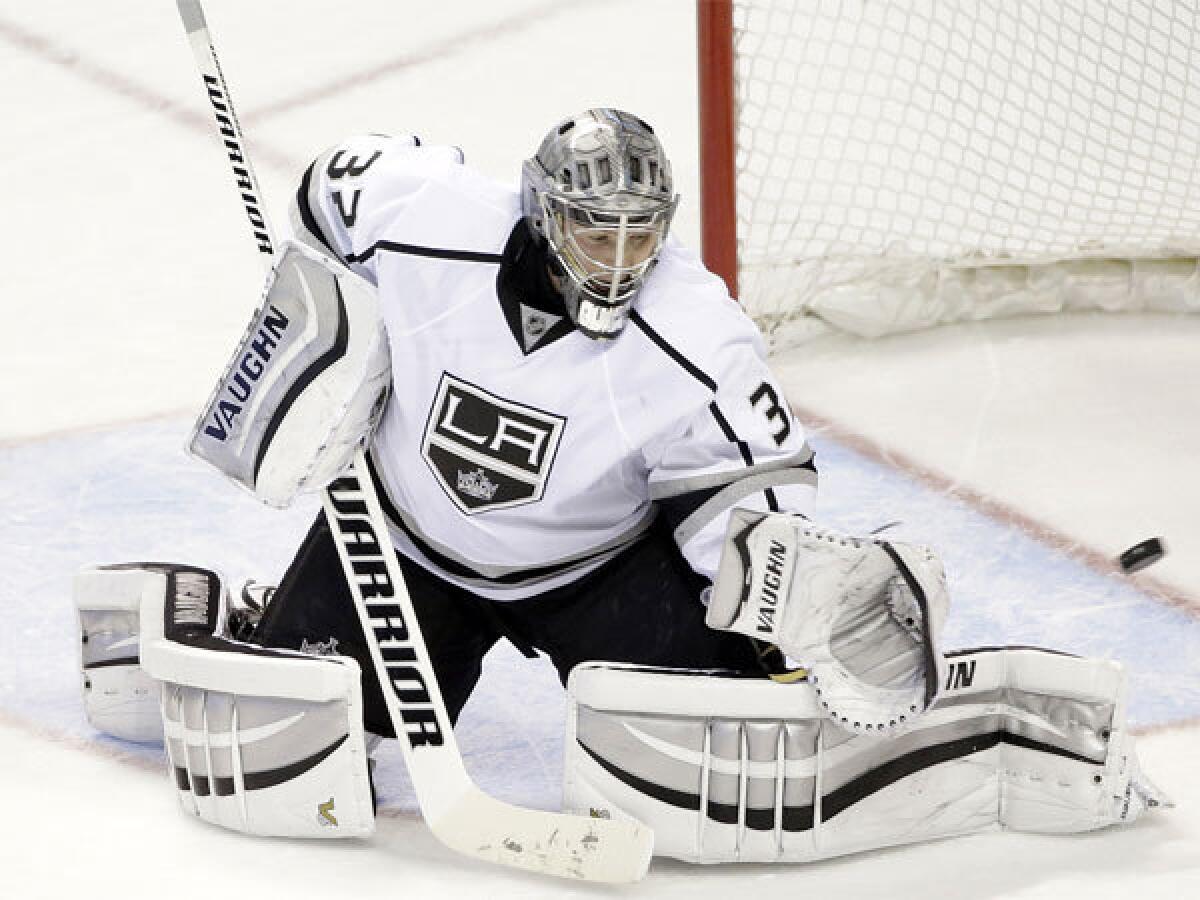 Kings' Jonathan Quick deflects a shot on goal against the San Jose Sharks on Monday night.