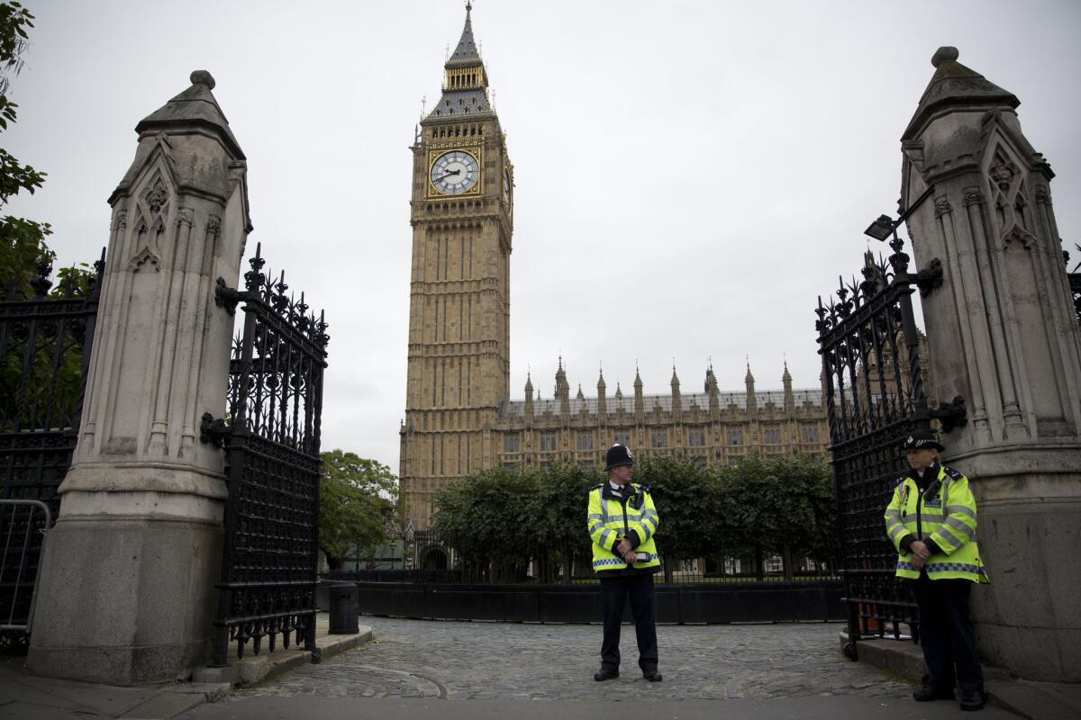 British police officers stand guard outside the Houses of Parliament in London on Monday.