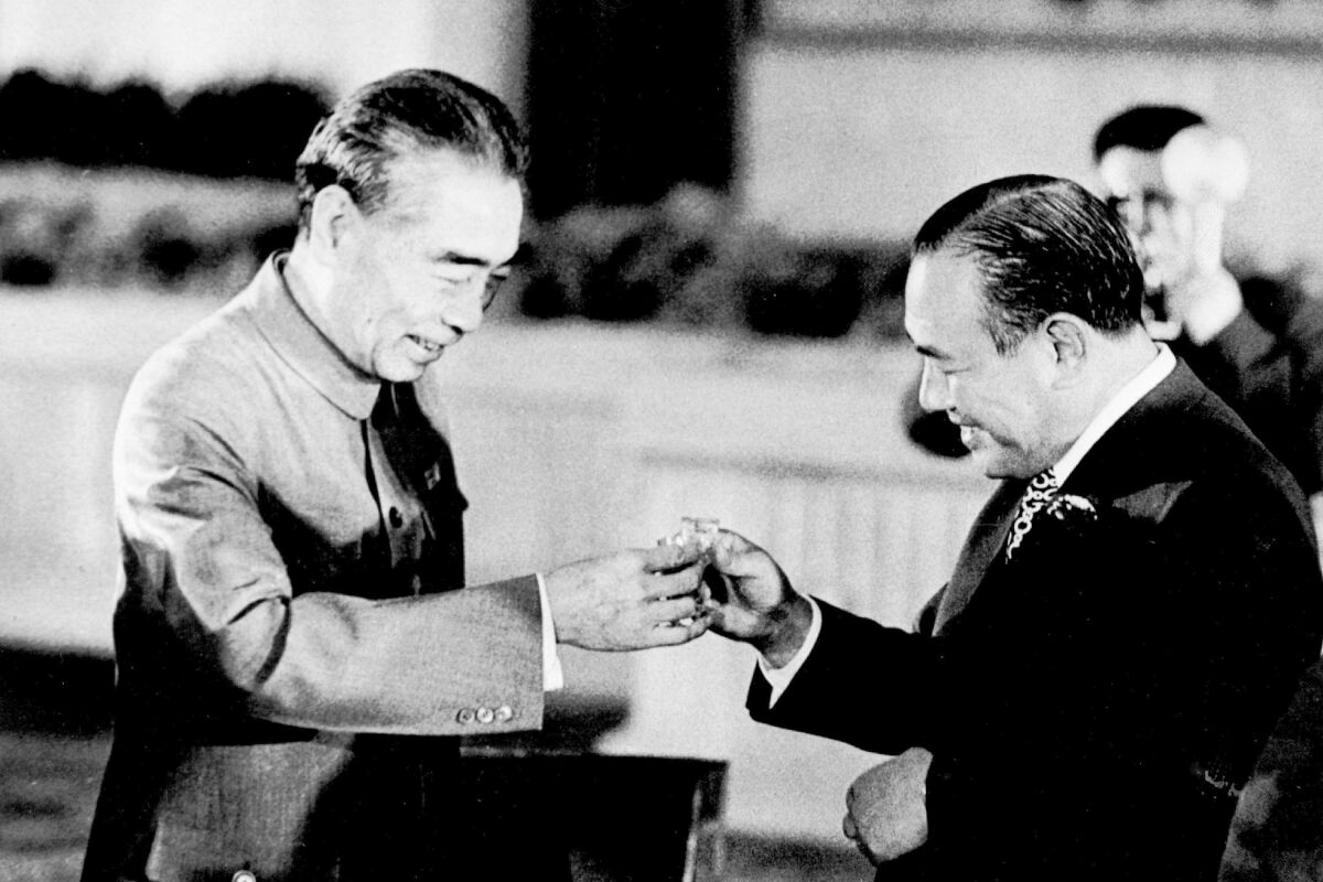 FILE - Chinese Premier Zhou Enlai, left, and Japanese Prime Minister Kakuei Tanaka toast each other at a banquet in the Hall of the People in Beijing on Sept. 28, 1972. Thursday, Sept. 29, 2022, marks the 50th anniversary of a historic communique for Japan to normalize relations with China that Tanaka signed with Zhou. (AP Photo, File)