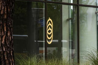 The Cosmax logo on a wall inside its building
