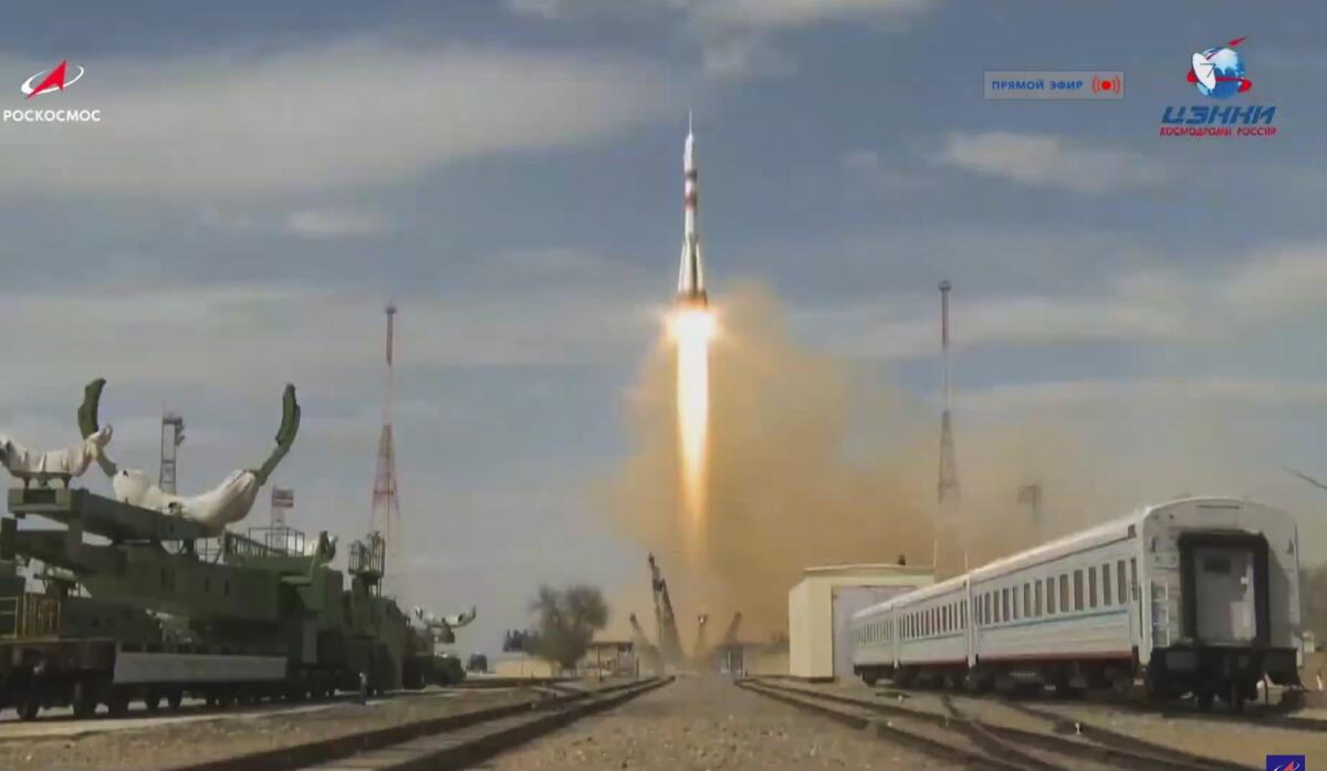 A rocket ship carrying a U.S.-Russian crew to the International Space Station blasts off from the Baikonur Cosmodrome in Kazakhstan.