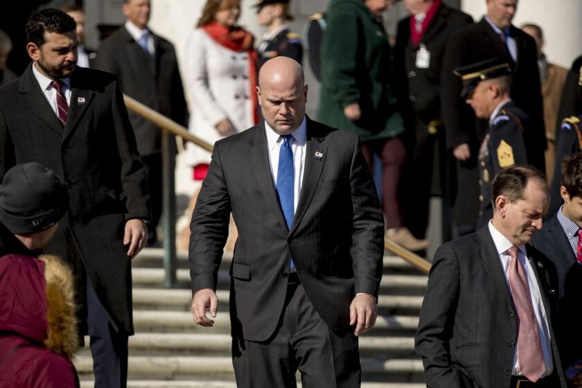 Acting United States Attorney General Matt Whitaker, center, and Labor Secretary Alex Acosta, second from right, attend a wreath laying ceremony at the Tomb of the Unknown Soldier during a ceremony at Arlington National Cemetery on Veterans Day, Sunday, Nov. 11, 2018, in Arlington, Va. (AP Photo/Andrew Harnik)