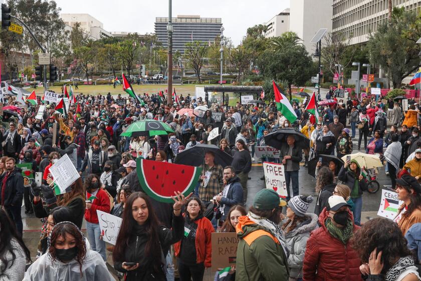 Los Angeles, CA - March 02: People protest outside of City Hall during a global day of action to end the Israeli Hamas war on Saturday, March 2, 2024 in Los Angeles, CA. (Michael Blackshire / Los Angeles Times)