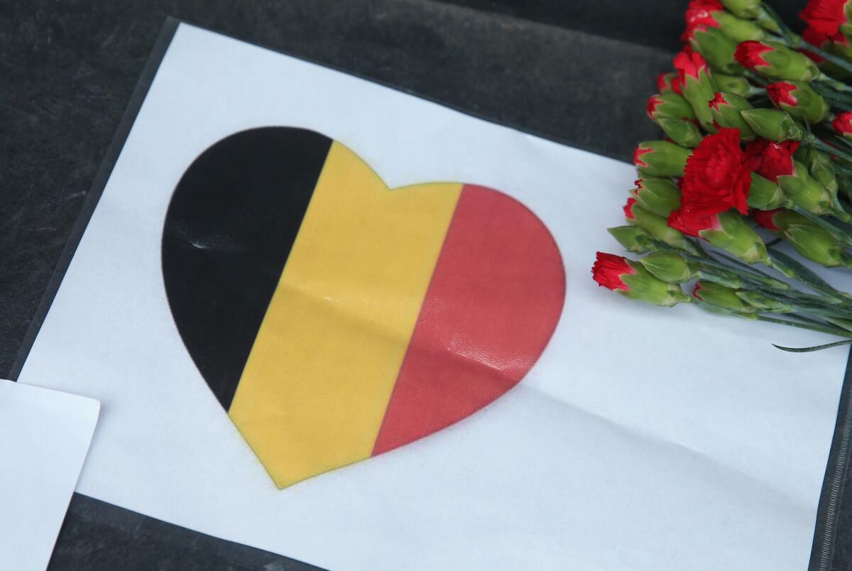 A heart with the colors of the Belgian flag lies among flowers at the steps of the Belgian Embassy in Berlin following the terrorist attacks in Brussels on March 22, 2016.