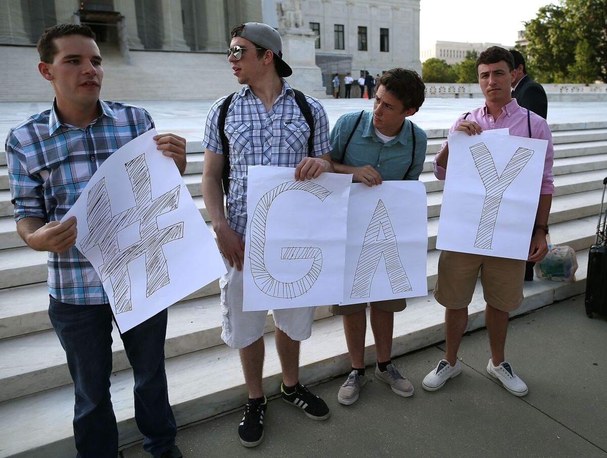 Gay rights activists gather in front of the U.S. Supreme Court on Wednesday.