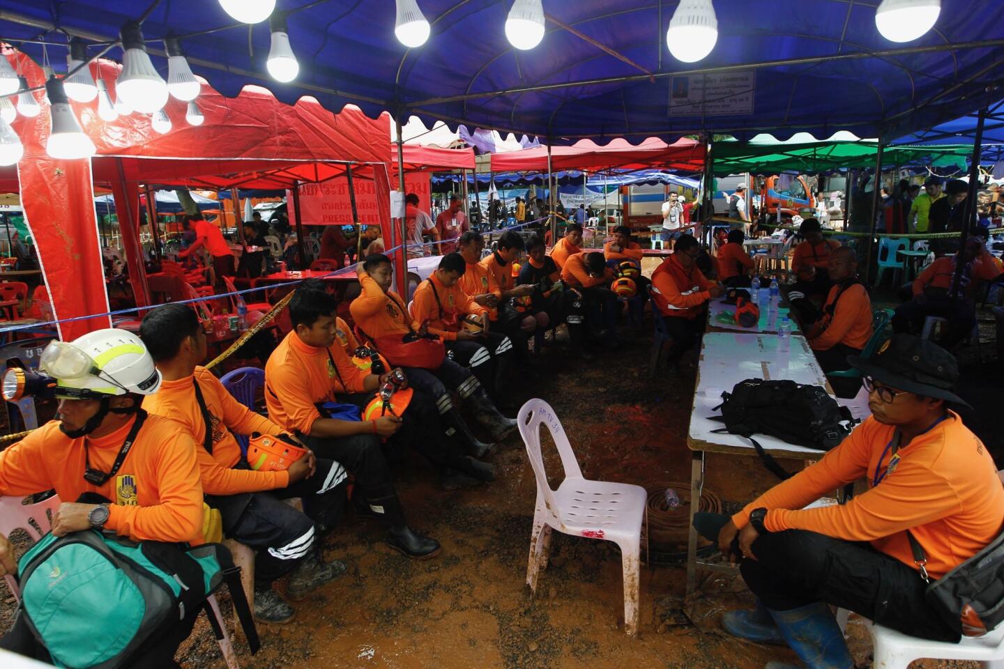 Thai civil defense volunteers prepare to join the rescue operation for the 12 trapped boys and their coach Sunday at Tham Luang cave.