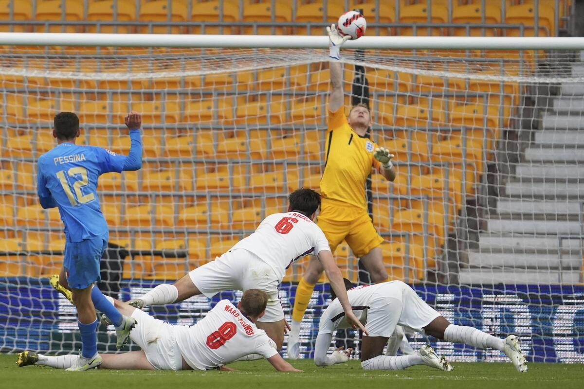Goalkeeper Aaron Ramsdale of England makes a save during the Nations League soccer match between England and Italy at Molineux Stadium in Wolverhampton, England, Saturday, June 11, 2022. (AP Photo/Jon Super)