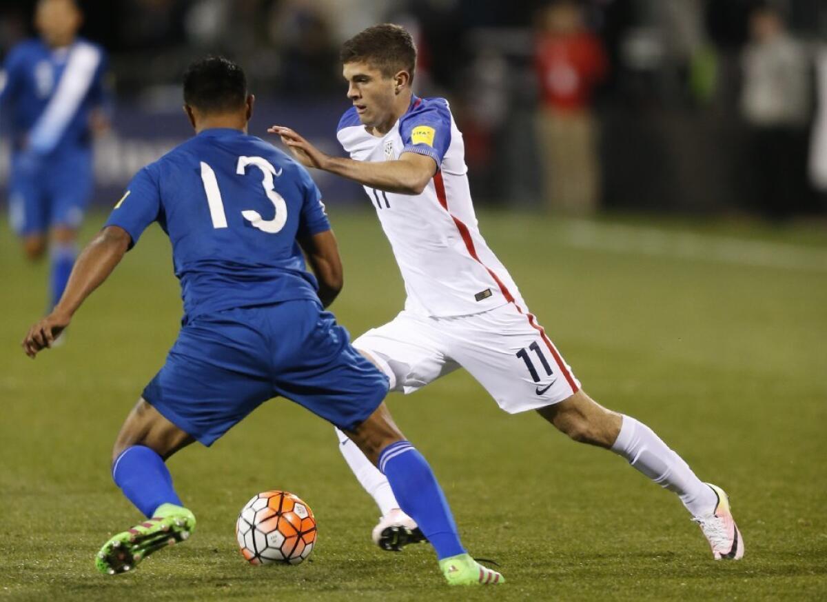 Christian Pulisic, right, then wearing No. 11, works against a Guatemalan defender during a World Cup qualifying match on March 29.