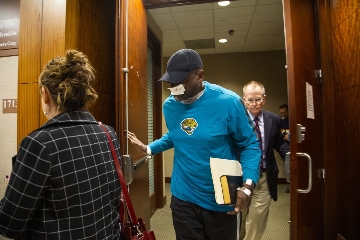 FILE - Former Houston police officer Gerald Goines, center, exits the 338th District Criminal Court on Jan. 9, 2020, in Houston. A judge said Thursday, July 21, 2022, that a man who has been serving a 25-year prison sentence based mostly on testimony from the ex-Houston police officer whose cases are being reviewed following a 2019 deadly drug raid should have his conviction overturned. (Marie D. De Jesús/Houston Chronicle via AP, File)