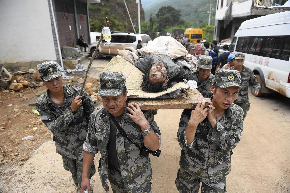 Rescuers carry an injured earthquake victim in Ludian County in southwestern China's Yunnan province.