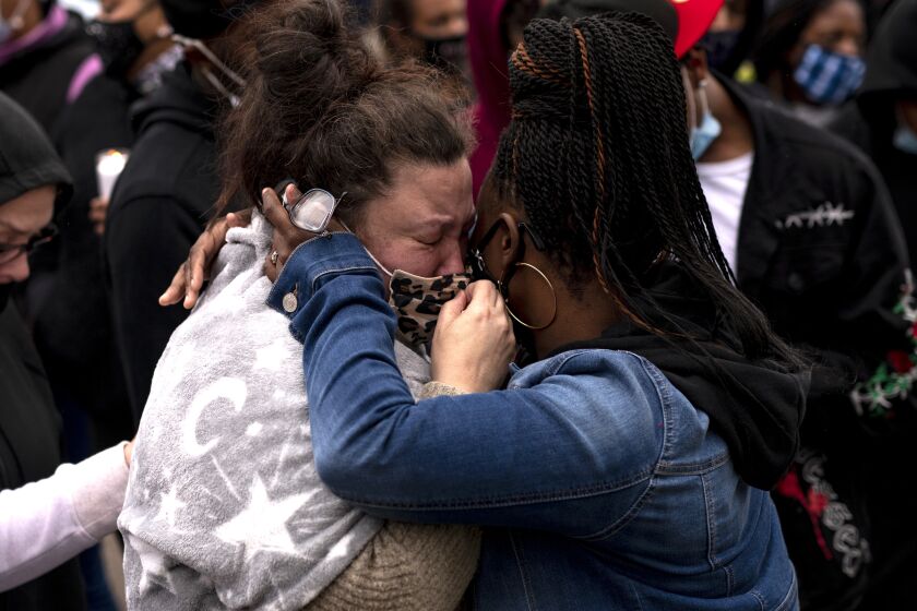 BROOKLYN CENTER, MN - APRIL 12: Katie Wright (L), the mother of Daunte Wright, is embraced during a vigil for her son on April 12, 2021 in Brooklyn Center, Minnesota. Wright was shot and killed yesterday by Brooklyn Center police during a traffic stop. (Photo by Stephen Maturen/Getty Images)