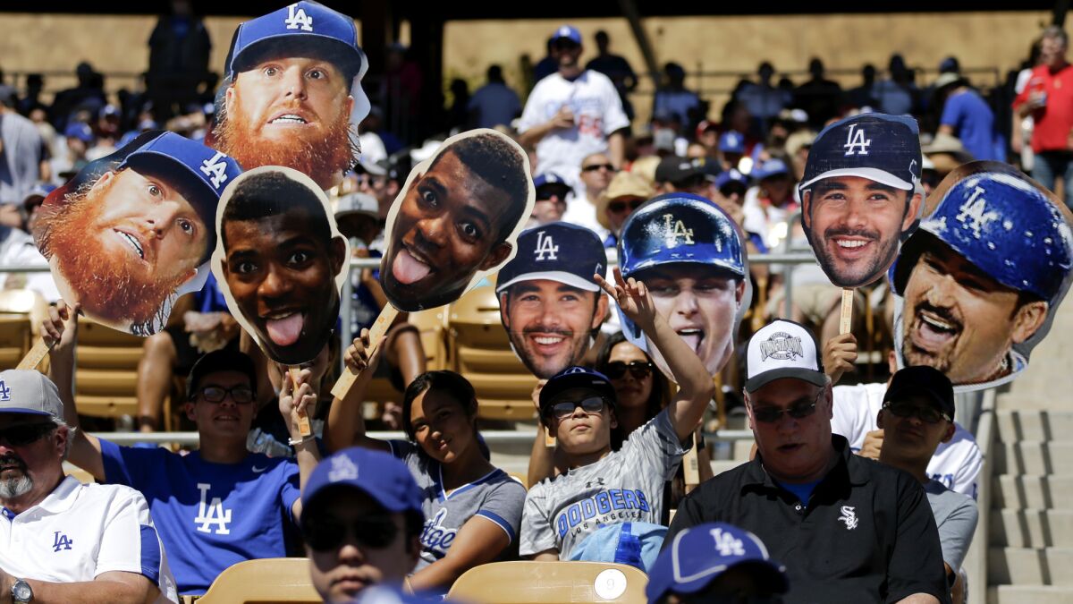 Fans cheer for the Dodgers during a spring training game against the White Sox on Saturday in Glendale, Ariz.