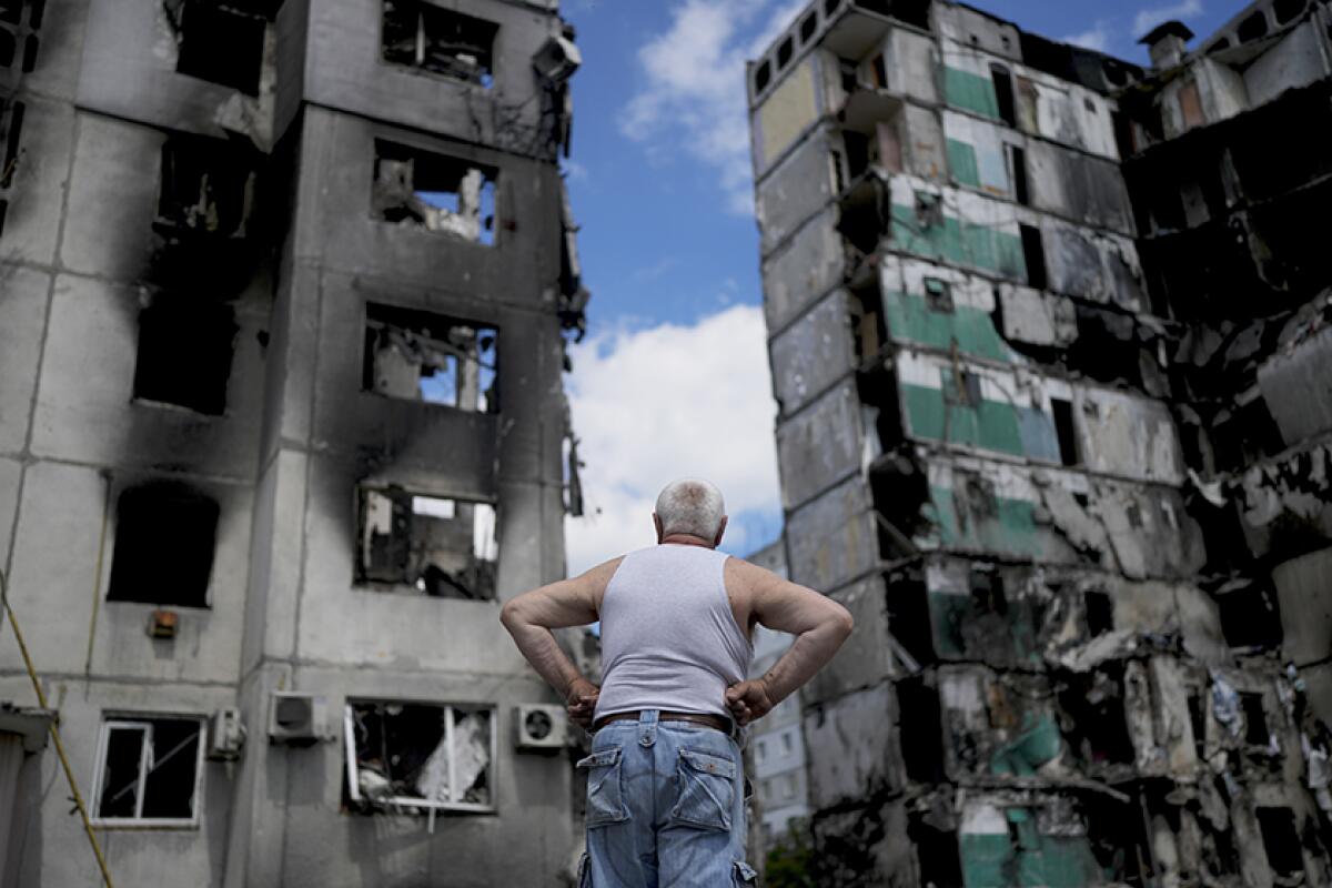 A man observes demolished buildings in Borodyanka, a town on the outskirts of Kyiv, Ukraine.