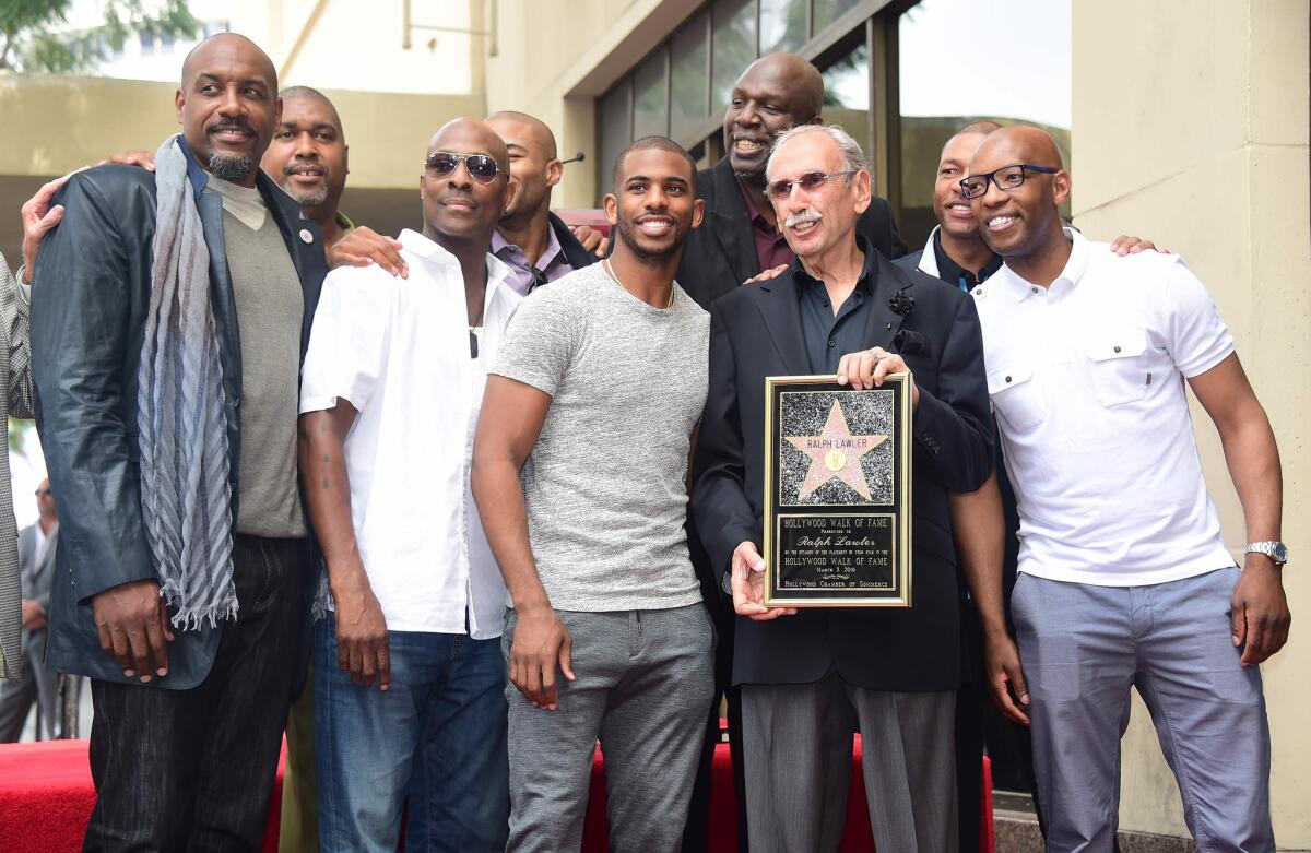 Sportscaster Ralph Lawler poses with former and present Clippers players, including Chris Paul, after Lawler received a star on the Hollywood Walk of Fame.