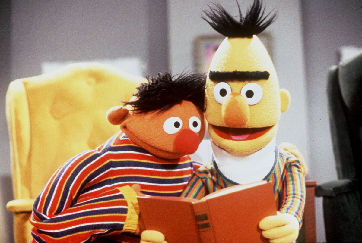 Two puppets read a book.