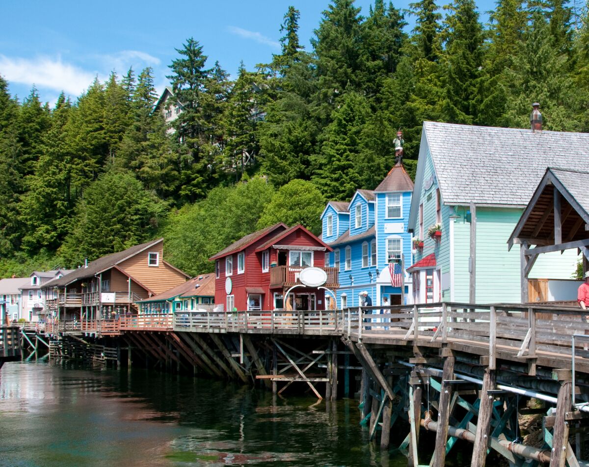 Row of shops at the Creek street in Ketchikan, Alaska. The least expensive way to see Alaska's glaciers and cities such as Ketchikan just may be by cruise ship.