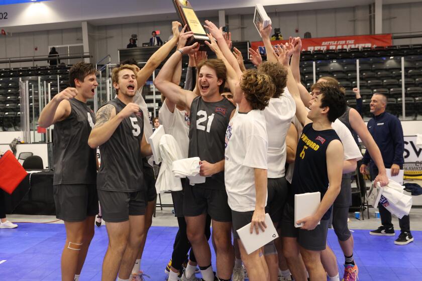 The Vanguard University men's volleyball team celebrates after winning the 2023 NAIA national championship on Saturday.