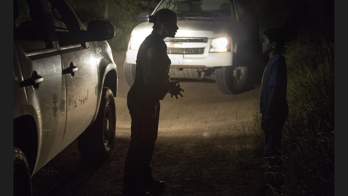 U.S. Border Patrol agent Marlene Castro, left, talks with an unaccompanied Honduran boy last month.