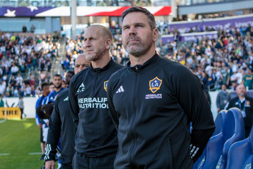 CARSON, CA - APRIL 1: Greg Vanney head coach of the LA Galaxy and team staff members stand.