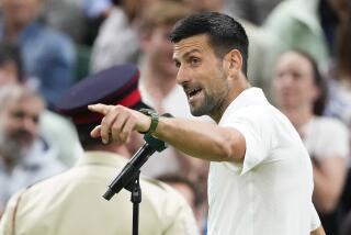 Novak Djokovic of Serbia gestures to the crowd as he is interviewed after defeating Holger Rune 