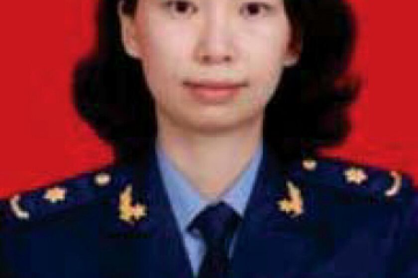 ADDS NO SALES RESTRICTION- FILE - This undated file photo provided by the U.S. Justice Department shows Juan Tang in her China People's Liberation Army military uniform. Tang a Chinese scientist charged with visa fraud after U.S. authorities said she concealed her military ties to China was arrested after she left the Chinese consulate in San Francisco to seek medical care for her asthma, court documents showed. A hearing on whether Tang, should be released on bail is scheduled for Friday, July 31, 2020. She is being held at a Sacramento County jail on behalf of federal authorities after her arrest last week. Tang and three other scientists living in the U.S., face charges of lying about their status as members of China's People's Liberation Army. All were charged with visa fraud, the Justice Department said. (Justice Department via AP,File)