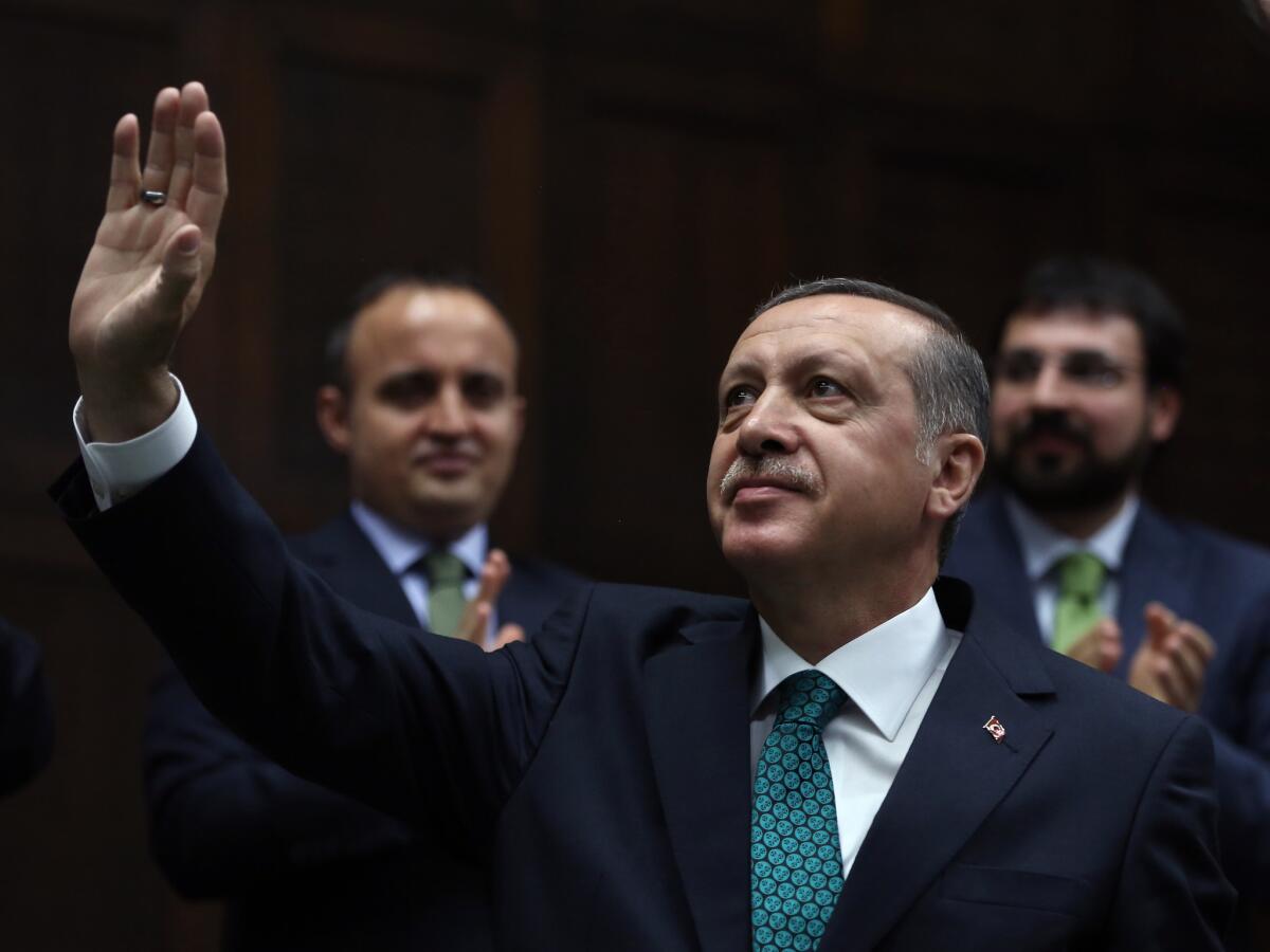 Turkish Prime Minister Recep Tayyip Erdogan salutes lawmakers and supporters at the parliament in Ankara on June 24.
