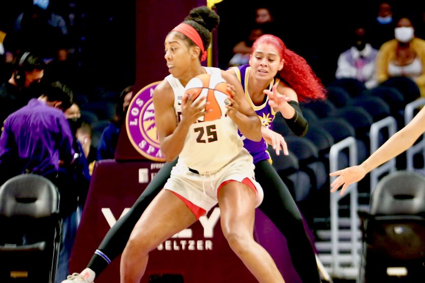 Sparks' Amanda Zahui B reaches to try to steal the ball from Atlanta Dream forward Monique Billings.