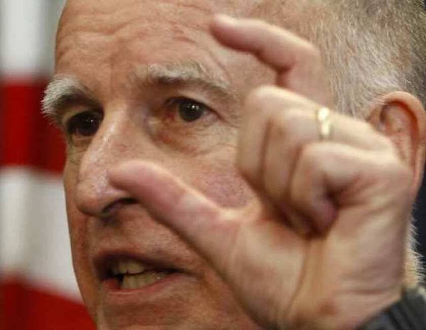 Gov. Jerry Brown, pictured here after vetoing the 2011 state budget, signed a bill to transfer responsibility for many California felons from state prisons to county jails.