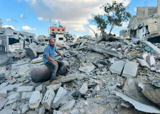 Mohammad Abu Warda sits amid rubble