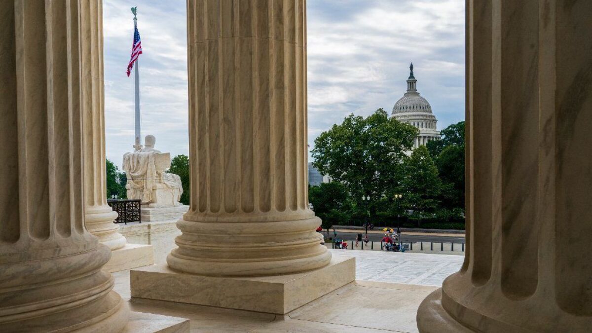 The Capitol is framed by the columns at the U.S. Supreme Court in Washington.