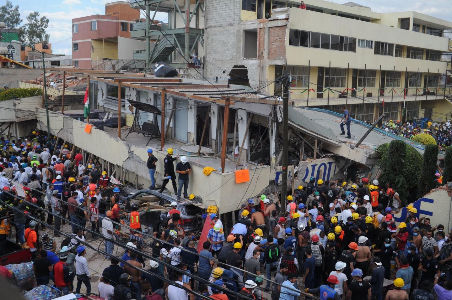 Rescuers work to free those trapped in collapsed school in Mexico City