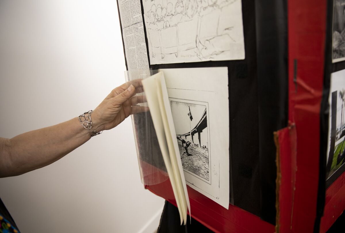Josephine Talamanez, founder, looks at items at the Chicano Park Museum and Cultural Center