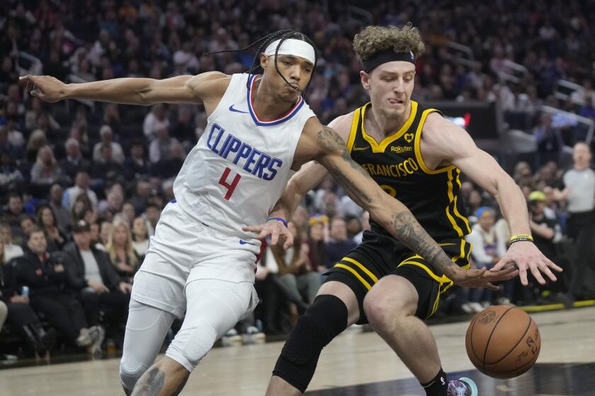 Los Angeles Clippers guard Brandon Boston Jr. (4) reaches for the ball next to Golden State Warriors guard Brandin Podziemski during the first half of an NBA basketball game in San Francisco, Wednesday, Feb. 14, 2024. (AP Photo/Jeff Chiu)