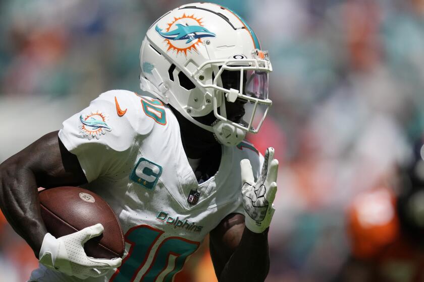 Miami Dolphins wide receiver Tyreek Hill (10) grabs a pass for a touchdown during the first half of an NFL football game against the Denver Broncos, Sunday, Sept. 24, 2023, in Miami Gardens, Fla. (AP Photo/Rebecca Blackwell)
